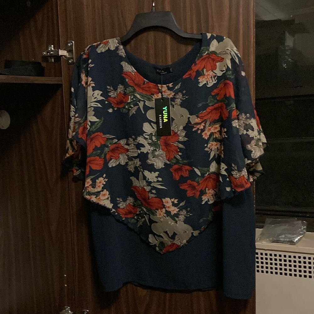 A beautiful top in size L/XL! Brand new with tags, light and airy.